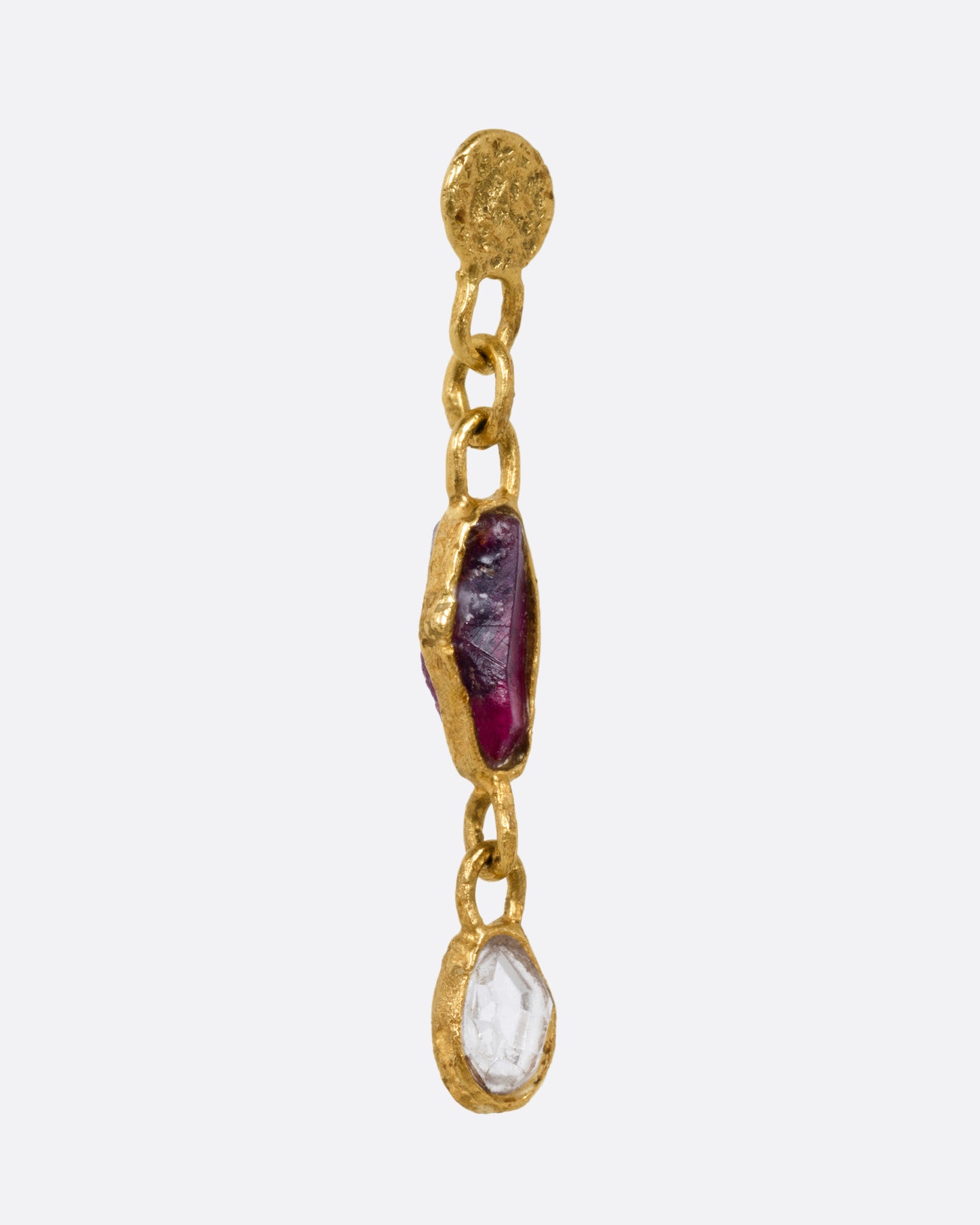 A yellow gold earring with a sapphire and diamond, shown from the side.