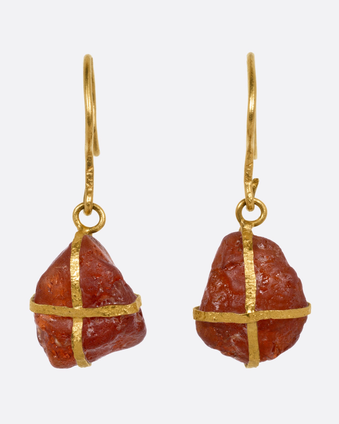 A pair of yellow gold drop earrings with gold wrapped raw rubelites, shown from the front.