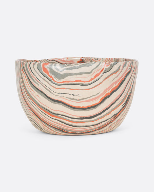 A ceramic bowl with peach, gray, and cream swirls. Shown from the front.