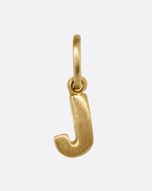 A yellow gold letter 'J' pendant shown from the front.