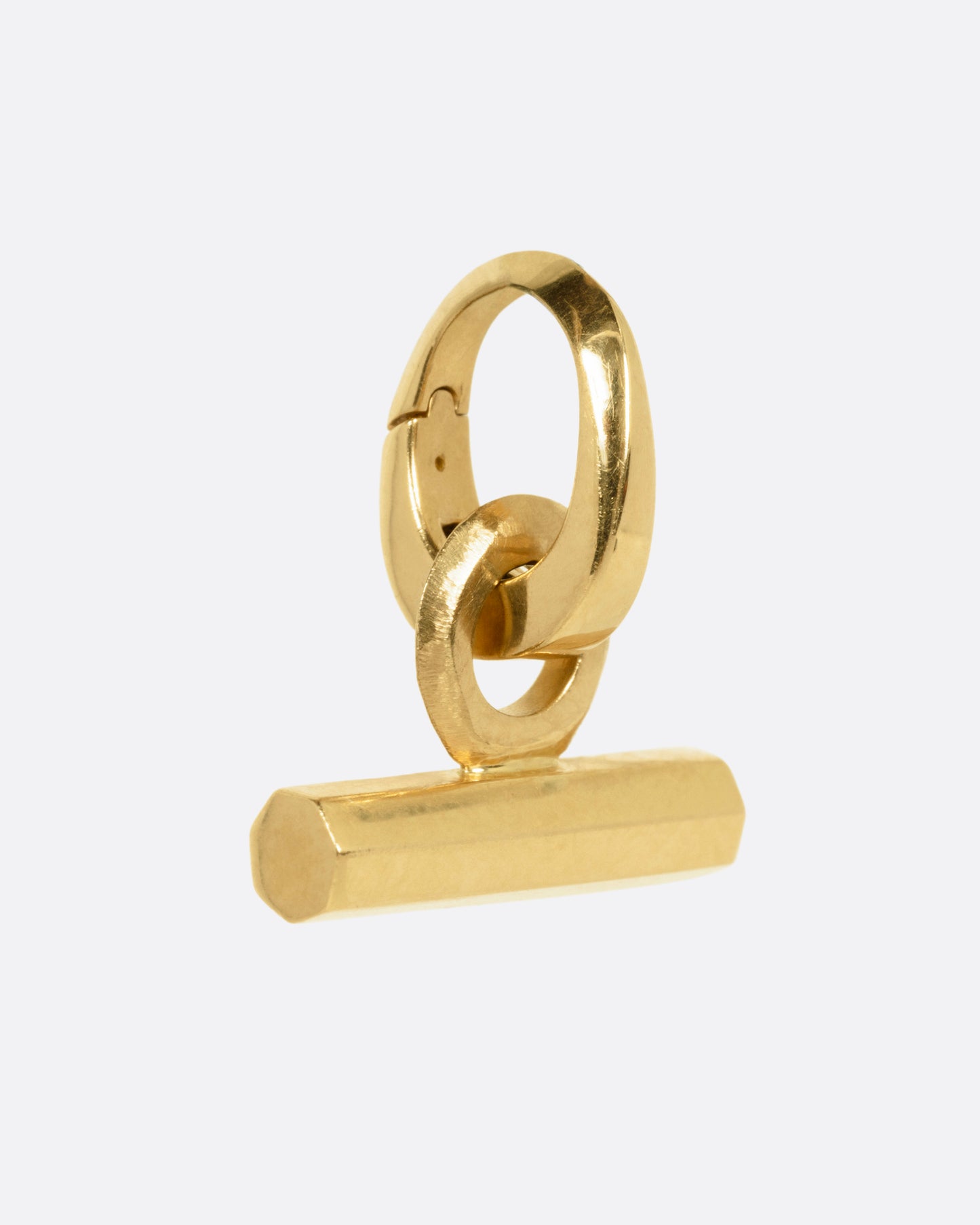 A yellow gold T-Bar charm shown from the side.