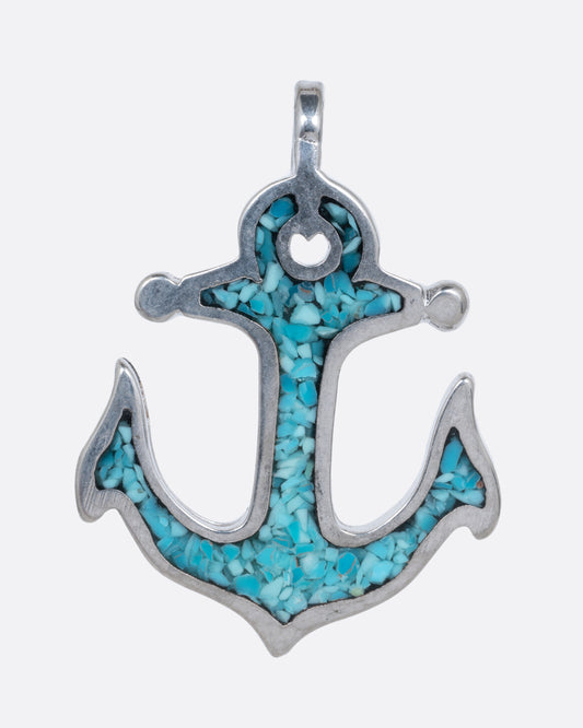 An alpaca silver anchor charm with turquoise chip inlay. Shown from the front.