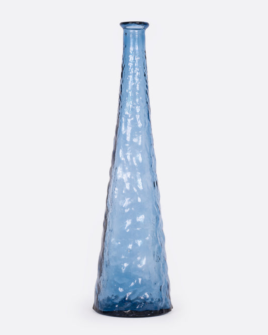A tall tapered blue glass vase with a textured exterior, shown from the front.