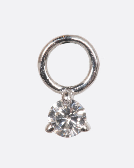 A dangle with a white gold prong setting and jump ring and a white diamond. Shown from the front.
