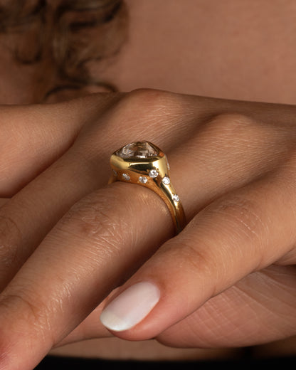 Yellow gold trillion diamond ring worn on a hand