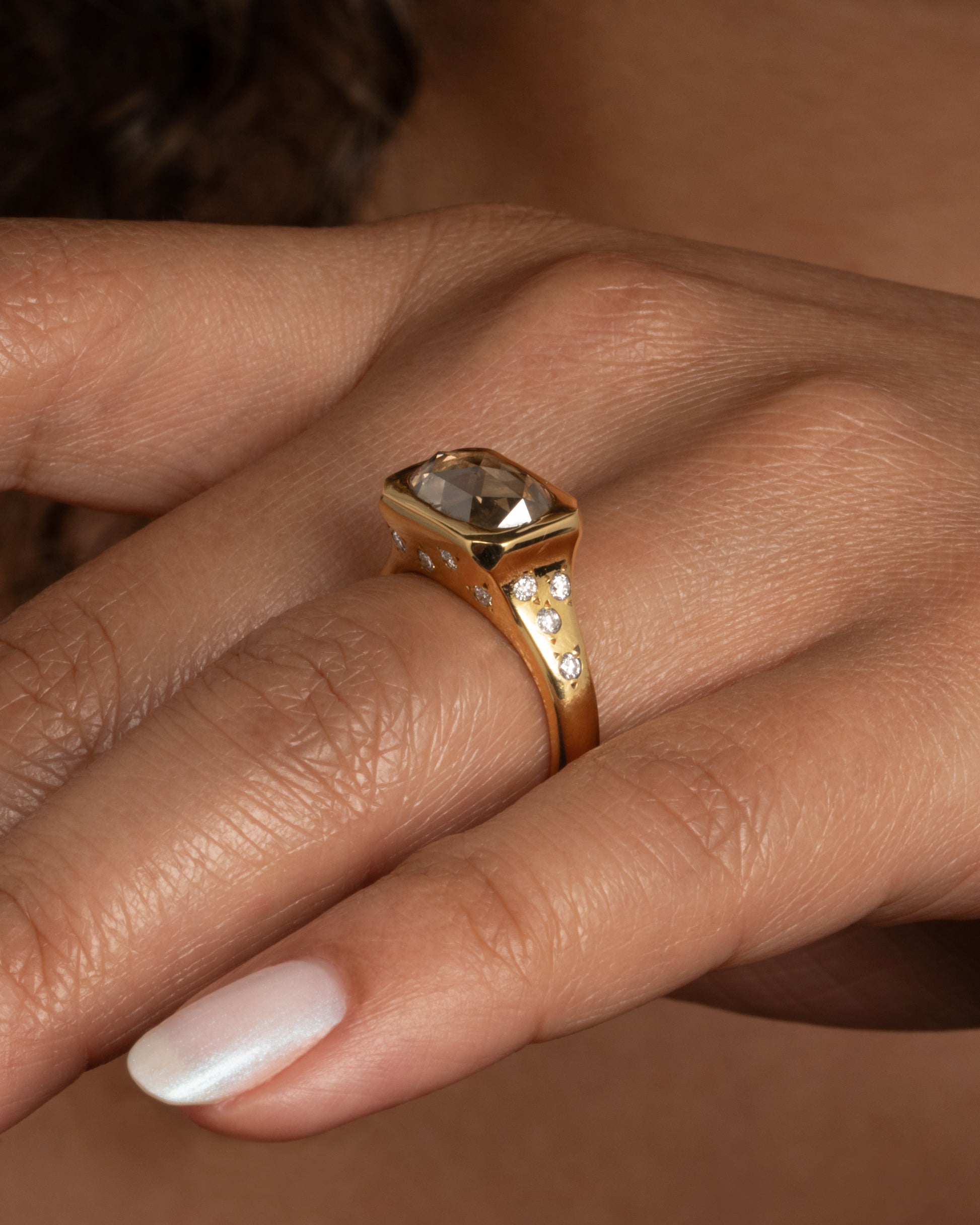This ring creates a balance between being classic, impactful and a bit playful. Shown worn on a finger.