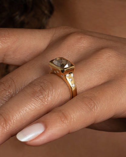 Yellow gold oval diamond ring worn on a hand