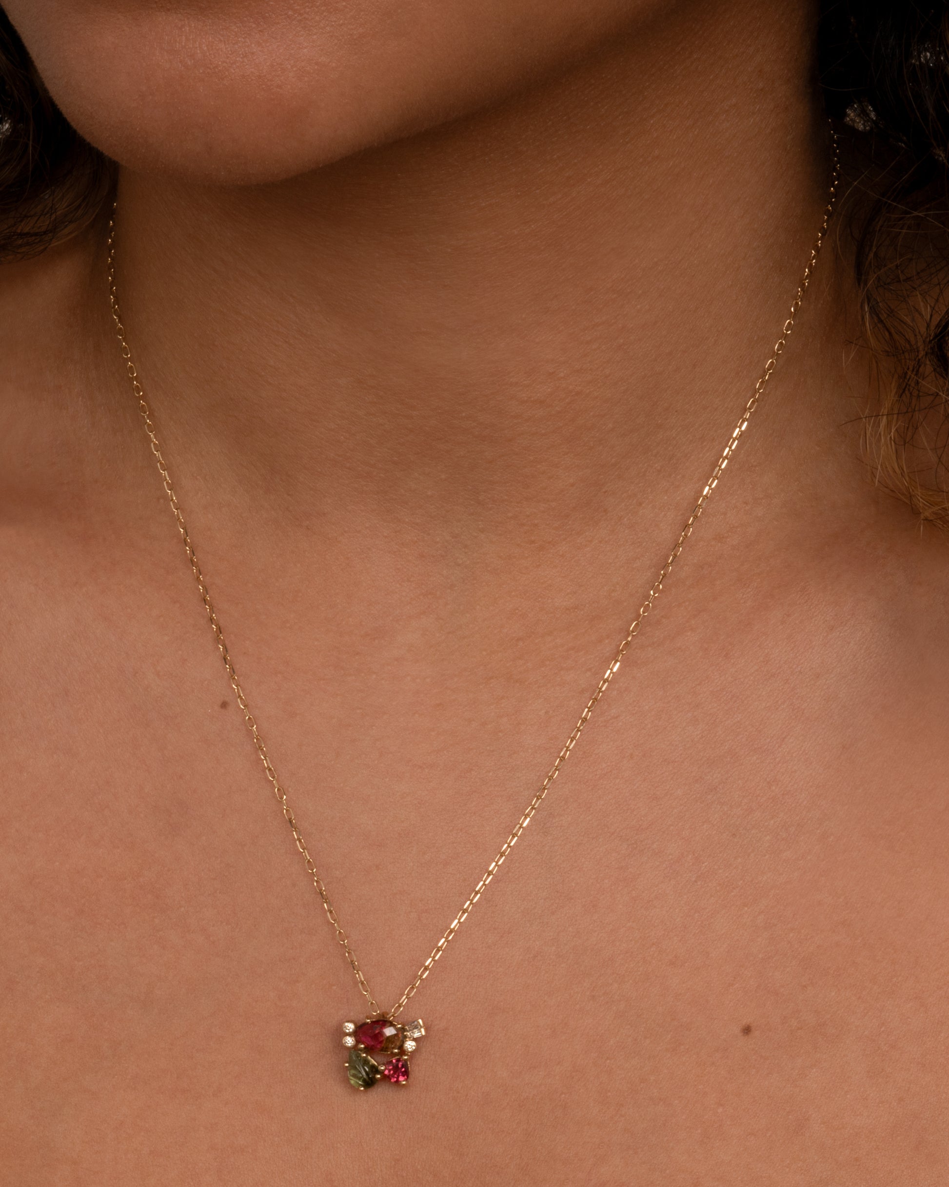 This vibrant, botanical pendant has no jump ring so sits directly on your chain. Shown worn around the neck.