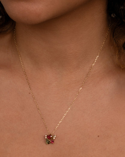 This vibrant, botanical pendant has no jump ring so sits directly on your chain. Shown worn around the neck.