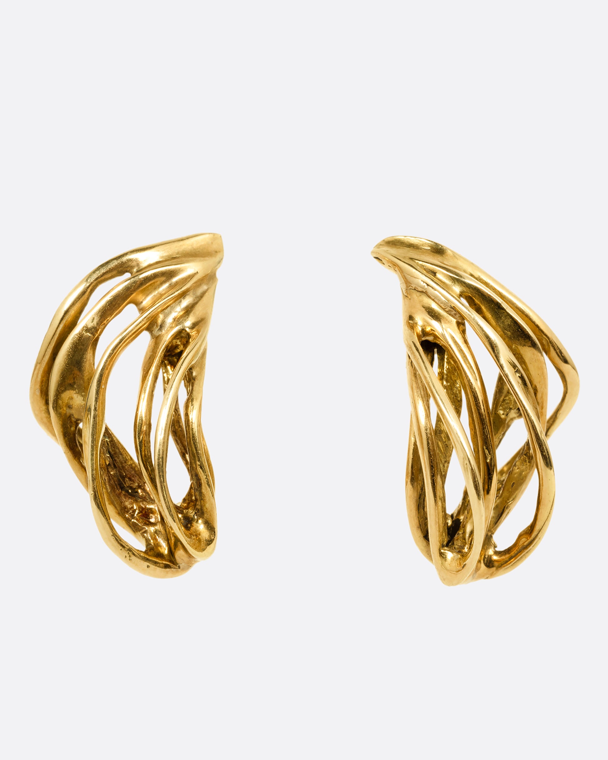 A pair of yellow gold stud earrings with clusters of  intertwined gold strands. Shown from the front.