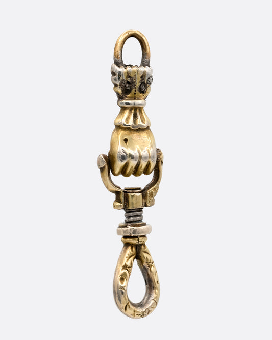A yellow gold charm holder with a 'knocker' style hand in a fist between each looped end. shown from the front.