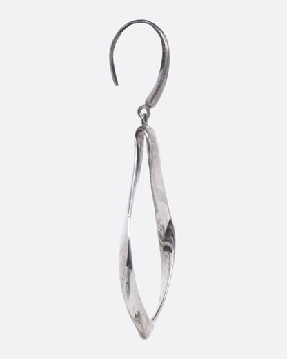 A silver drop earring with a twisted, open teardrop silhouette, shown from the side.
