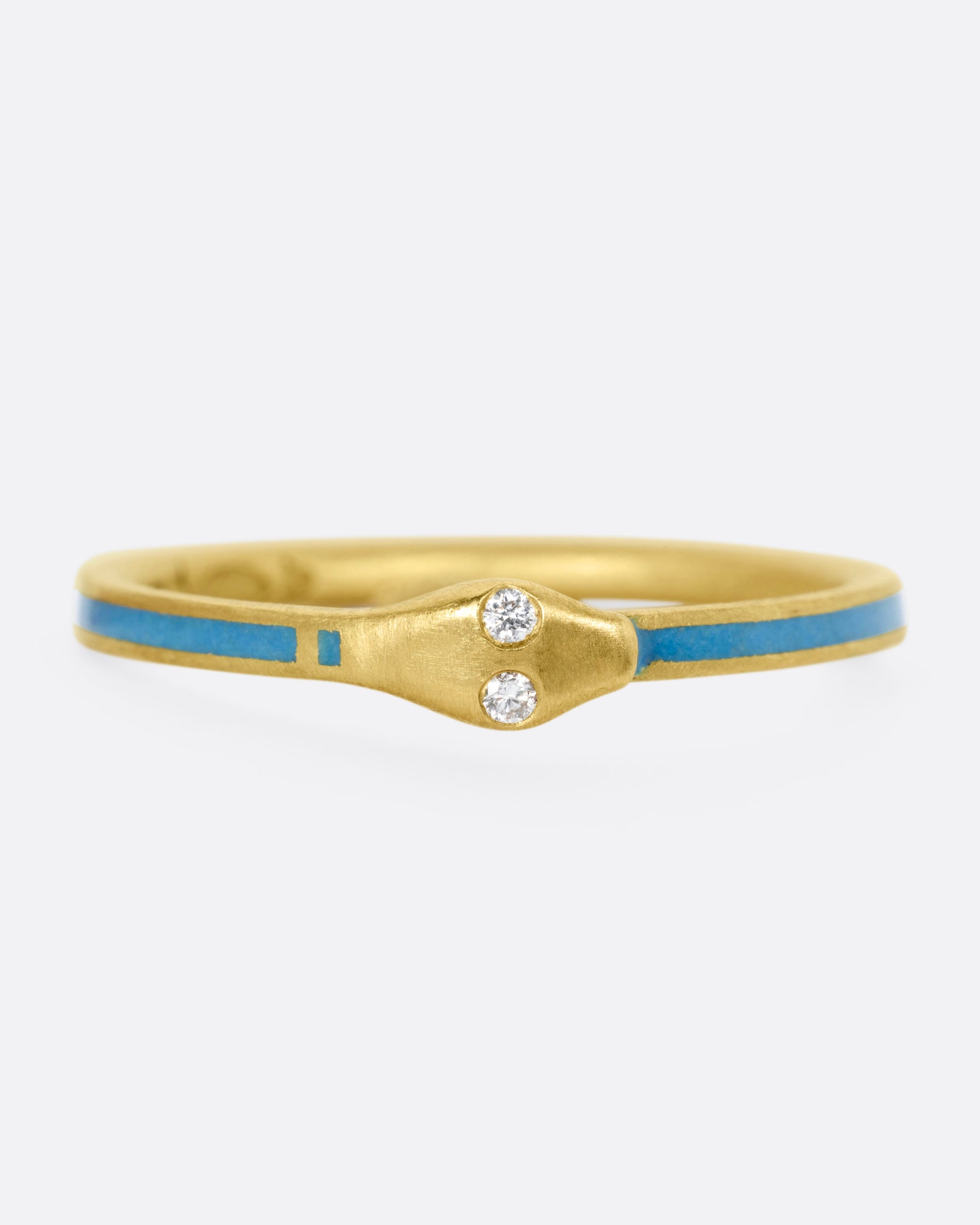 A yellow gold ouroboros ring with diamond eyes and pale blue enamel, shown from the front.
