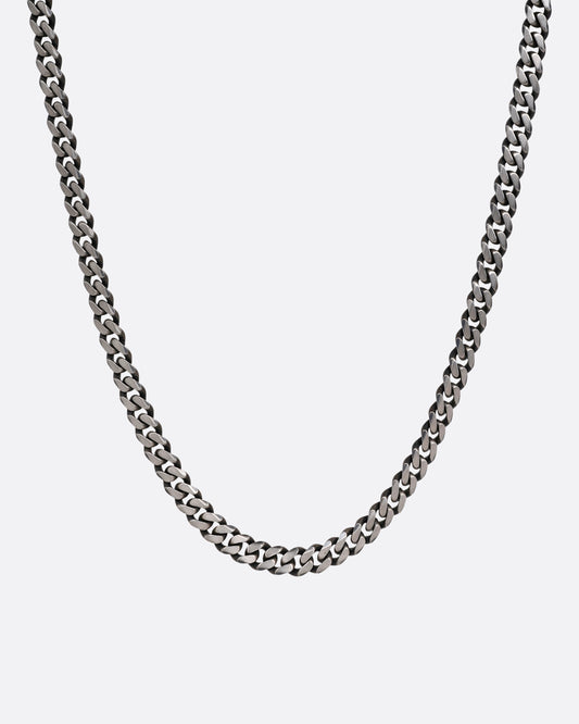 A silver curb chain necklace shown from the front.