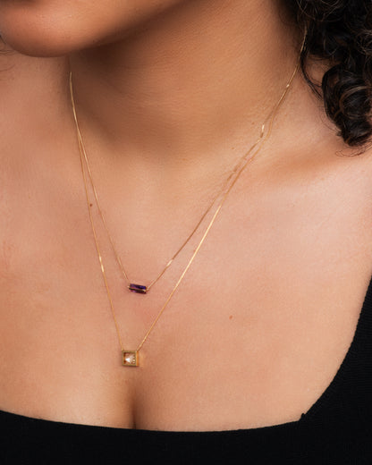 Yellow gold diamond slice necklace worn layered with a fine gold bar necklace