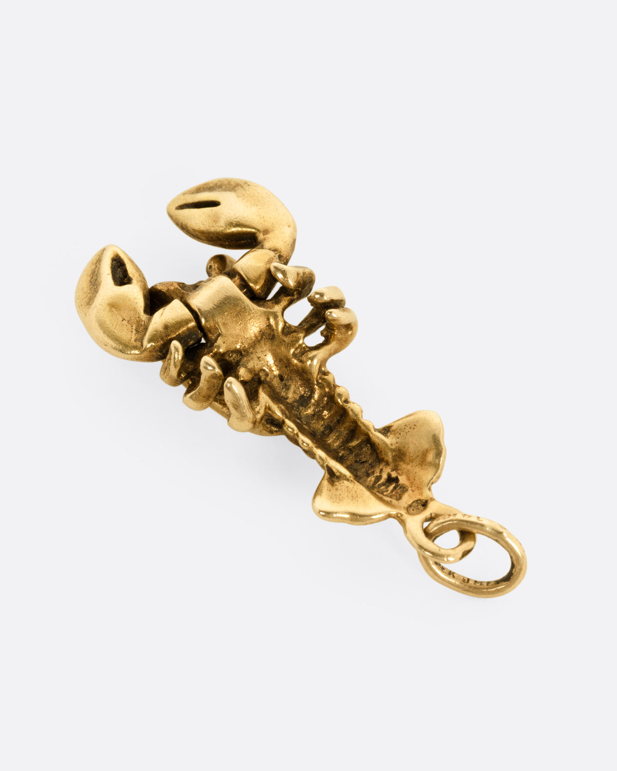 A yellow gold lobster pendant, shown from the back.