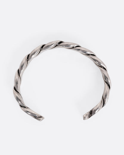 A silver twisted cuff bracelet, shown from the top.