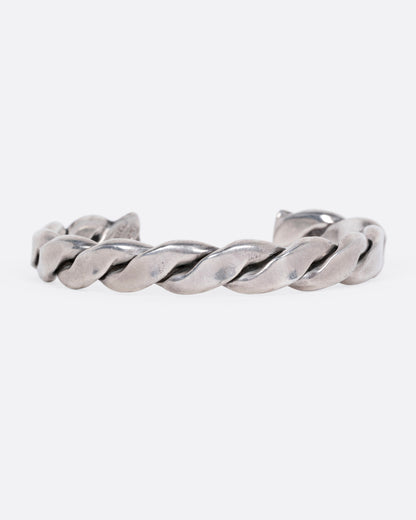 A silver twisted cuff bracelet, shown from the front.