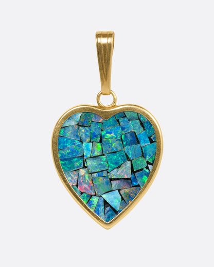 A yellow gold heart shaped pendant with opal inlay, shown from the front.