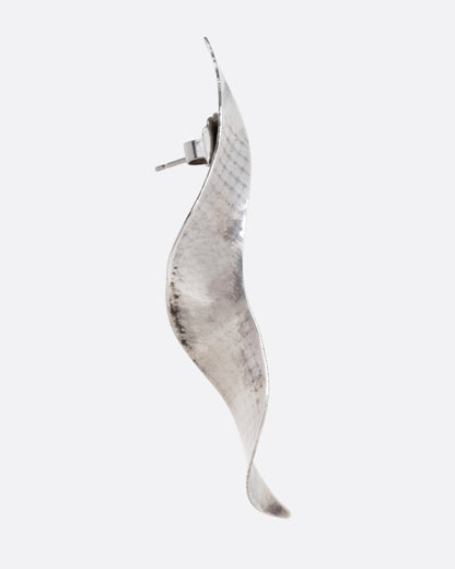 A silver twisty earring with a hammered finish, shown from the side.