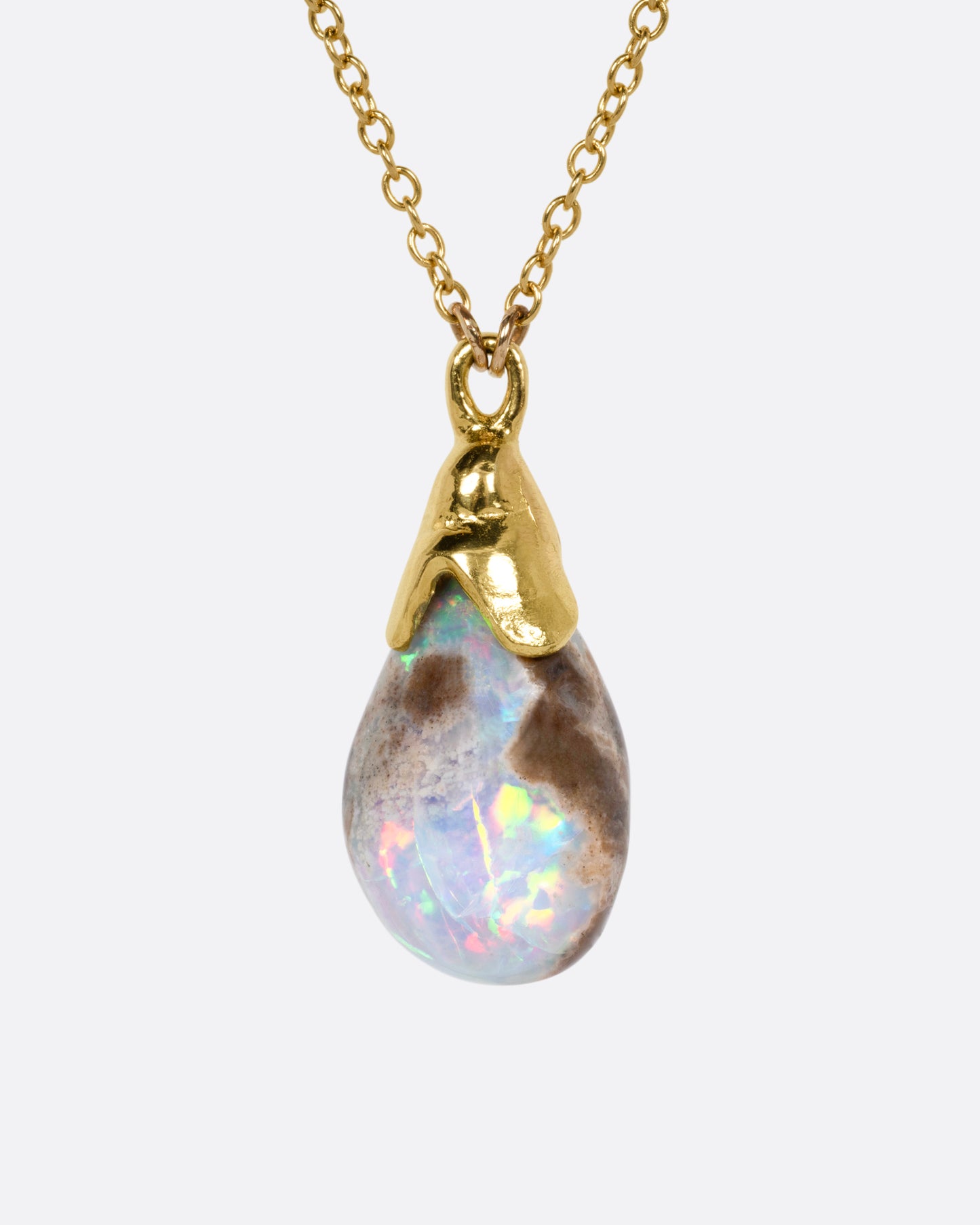 A yellow gold necklace with a teardrop shaped opal pendant, shown from the front.