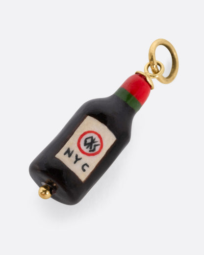 A porcelain wine bottle charm with "Romeo RED WINE" on the label and a yellow gold bail, shown from the back.