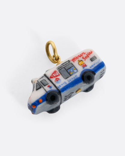 A porcelain 'Mister Softee' charm with a yellow gold bail, shown from the side.
