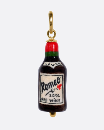 A porcelain wine bottle charm with "Romeo RED WINE" on the label and a yellow gold bail, shown from the front.