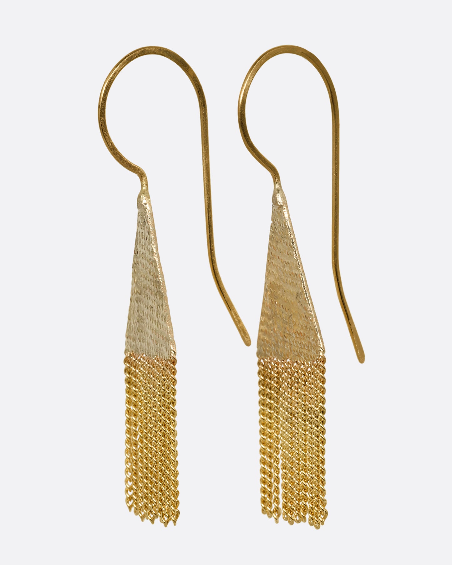 A pair of yellow gold drop earrings with diamond shaped tops and cable chain fringe bottoms. Shown from the side.