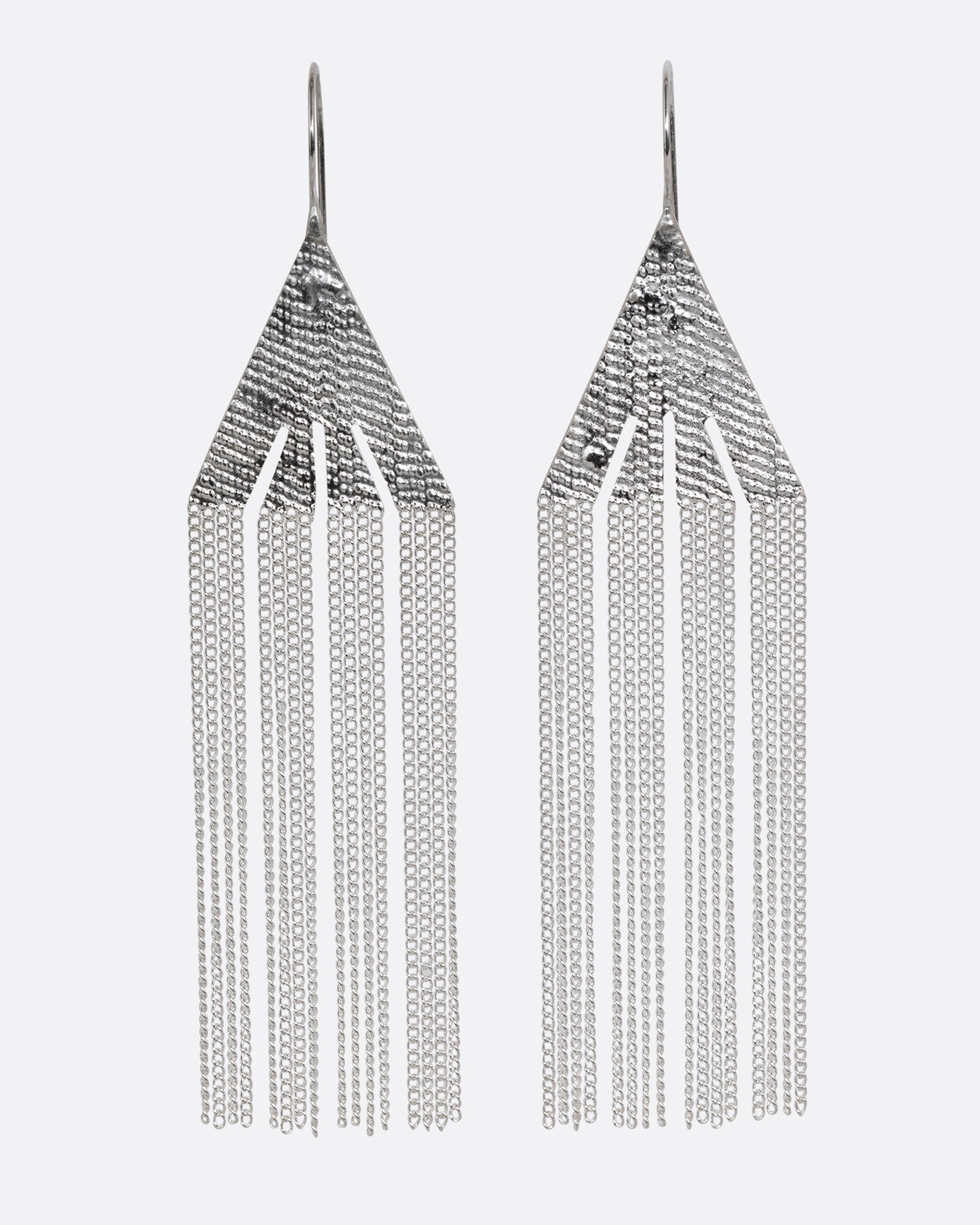 A pair of silver fringe earrings with triangular tops. Shown from the front.