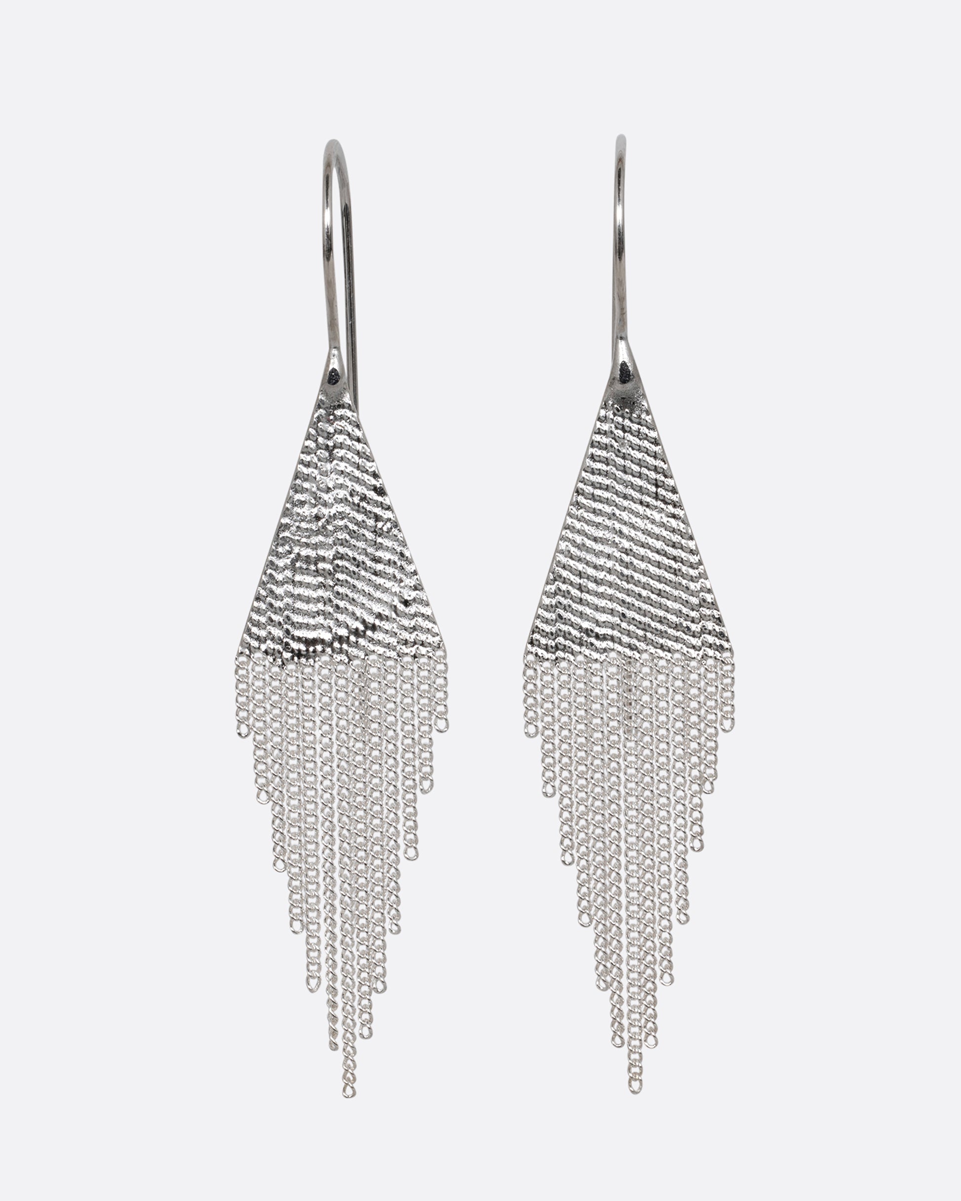 A pair of silver drop earrings with triangular tops and cable chain fringe bottoms. Shown from the front.