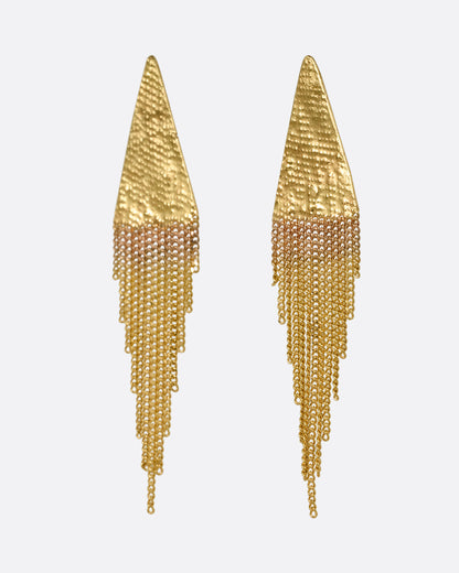 A pair of yellow gold earrings with triangular tops and cable chain fringe bottoms. Shown from the side.