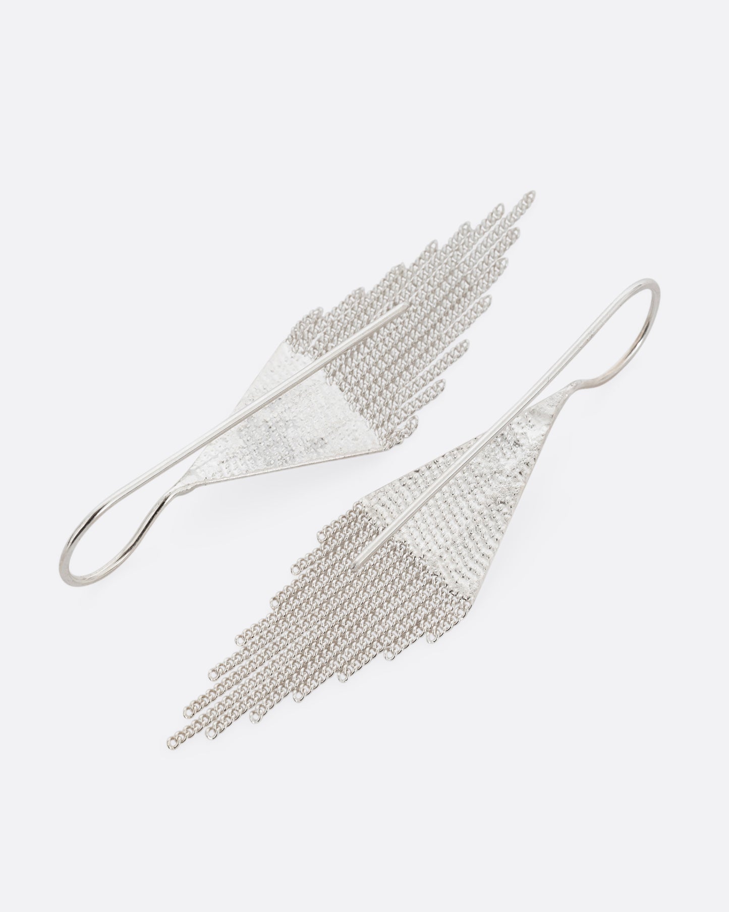 A pair of silver drop earrings with triangular tops and cable chain fringe bottoms. Shown from the back.
