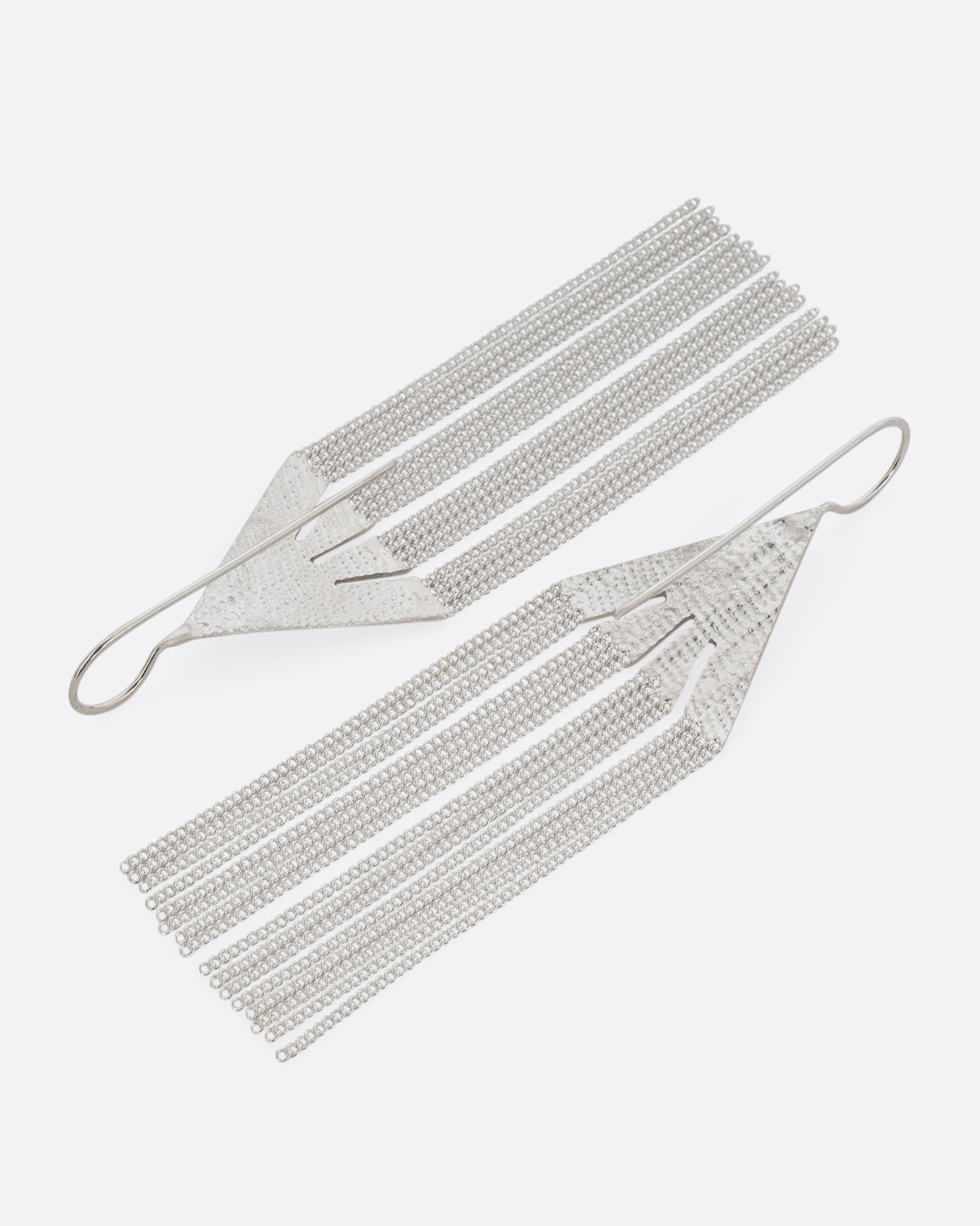A pair of silver fringe earrings with triangular tops. Shown from the back.