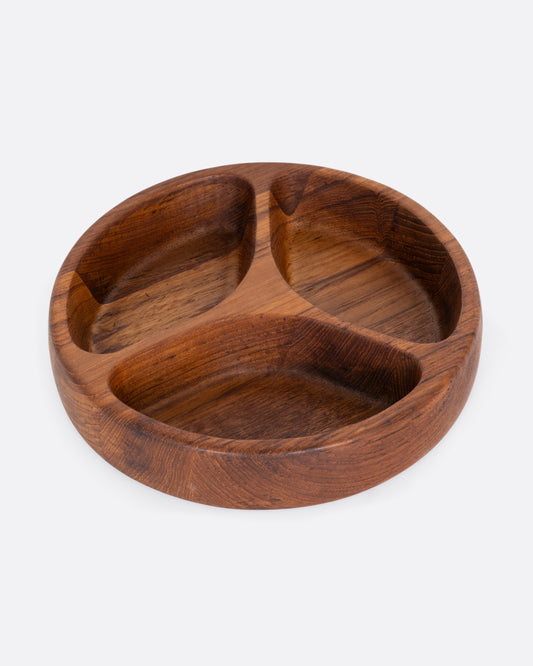 A round wooden tray with three separated sections. Shown from the top.