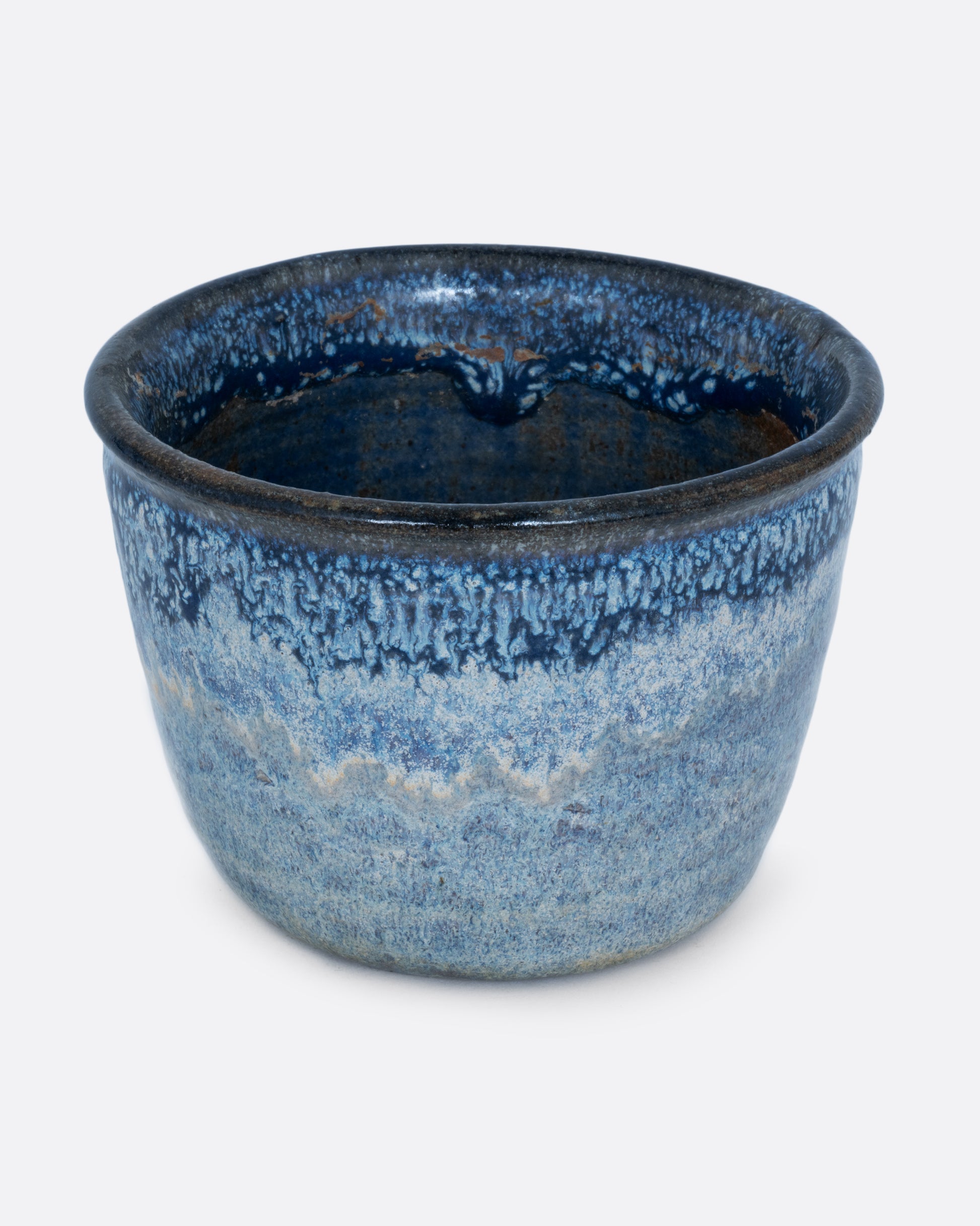 A pot with an azure glaze and drainage hole. Shown from the front.