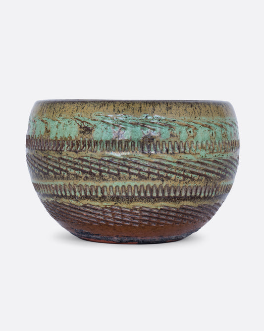 A round green textured pot shown from the front.