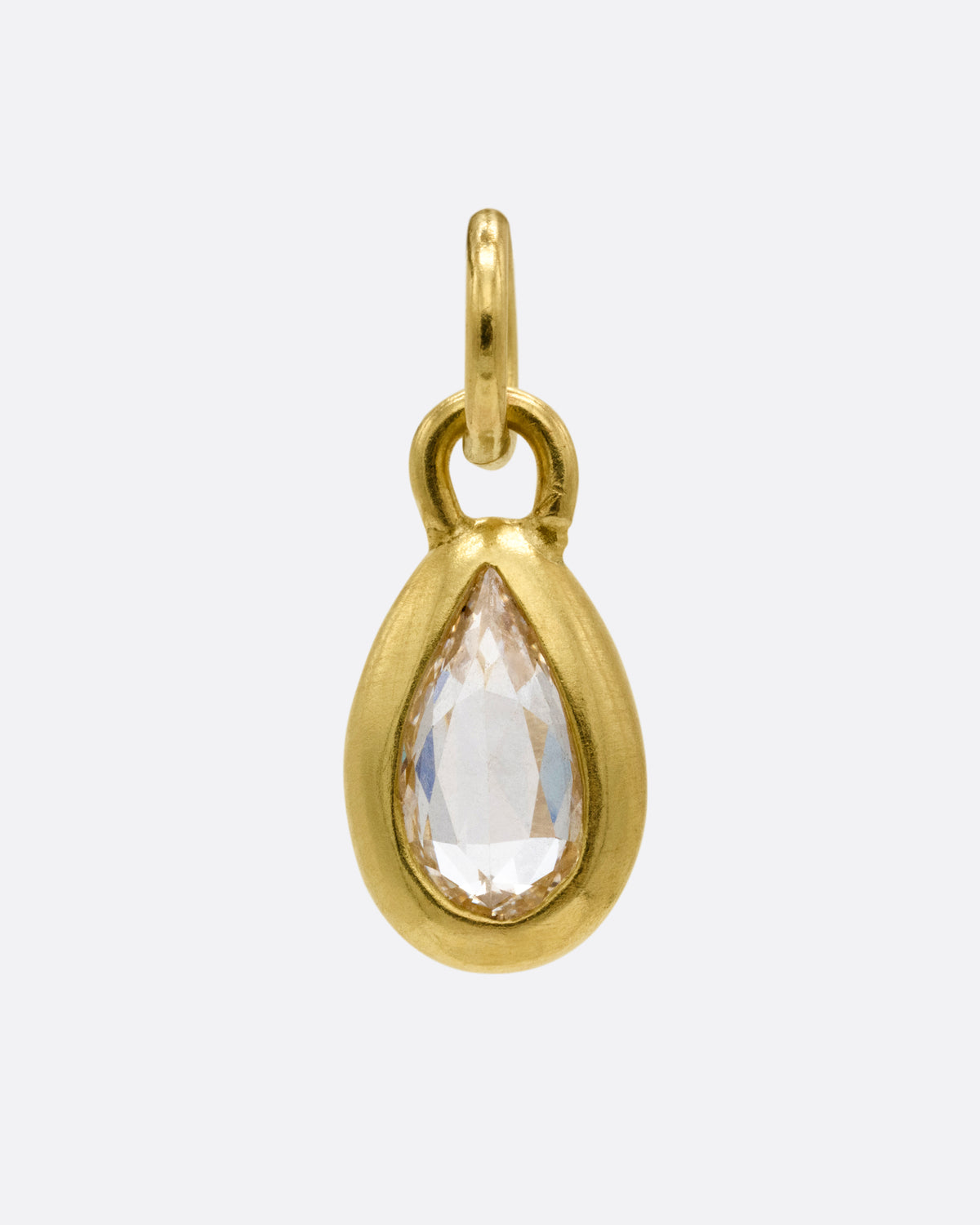 A yellow gold pear shaped and rose cut diamond charm shown from the front.