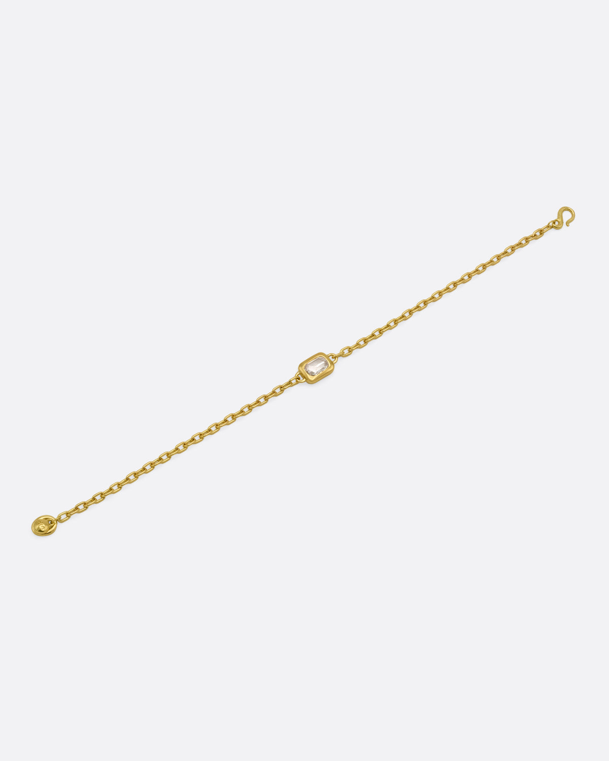 A yellow gold cable chain bracelet with a  rectangular rose cut diamond, shown from the front.