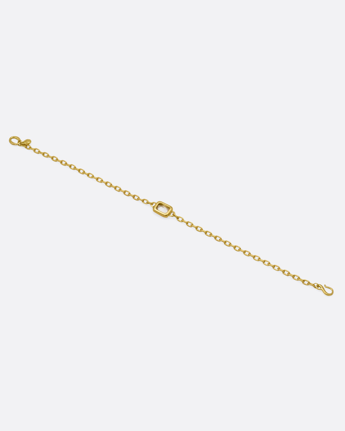 A yellow gold cable chain bracelet with a  rectangular rose cut diamond, shown from the back.