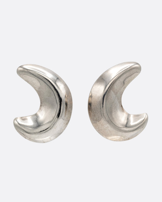A pair of silver crescent moon-shaped stud earrings, shown from the front.