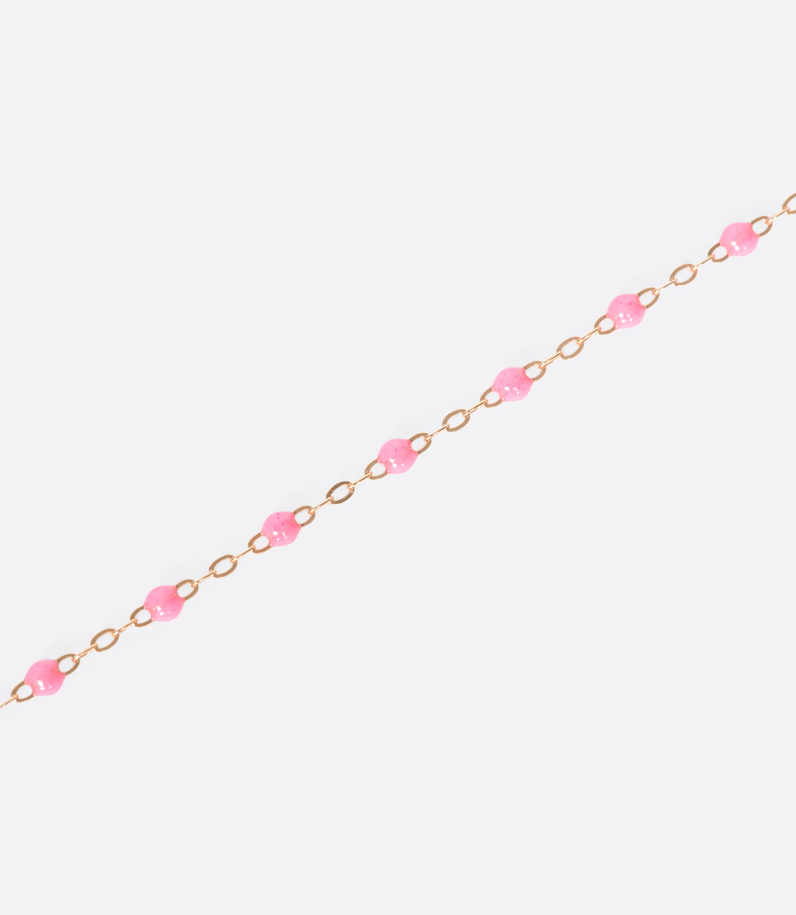 A thin rose gold chain necklace with resin beads. Each necklace is hand dipped in melted resin to create the beaded effect. 