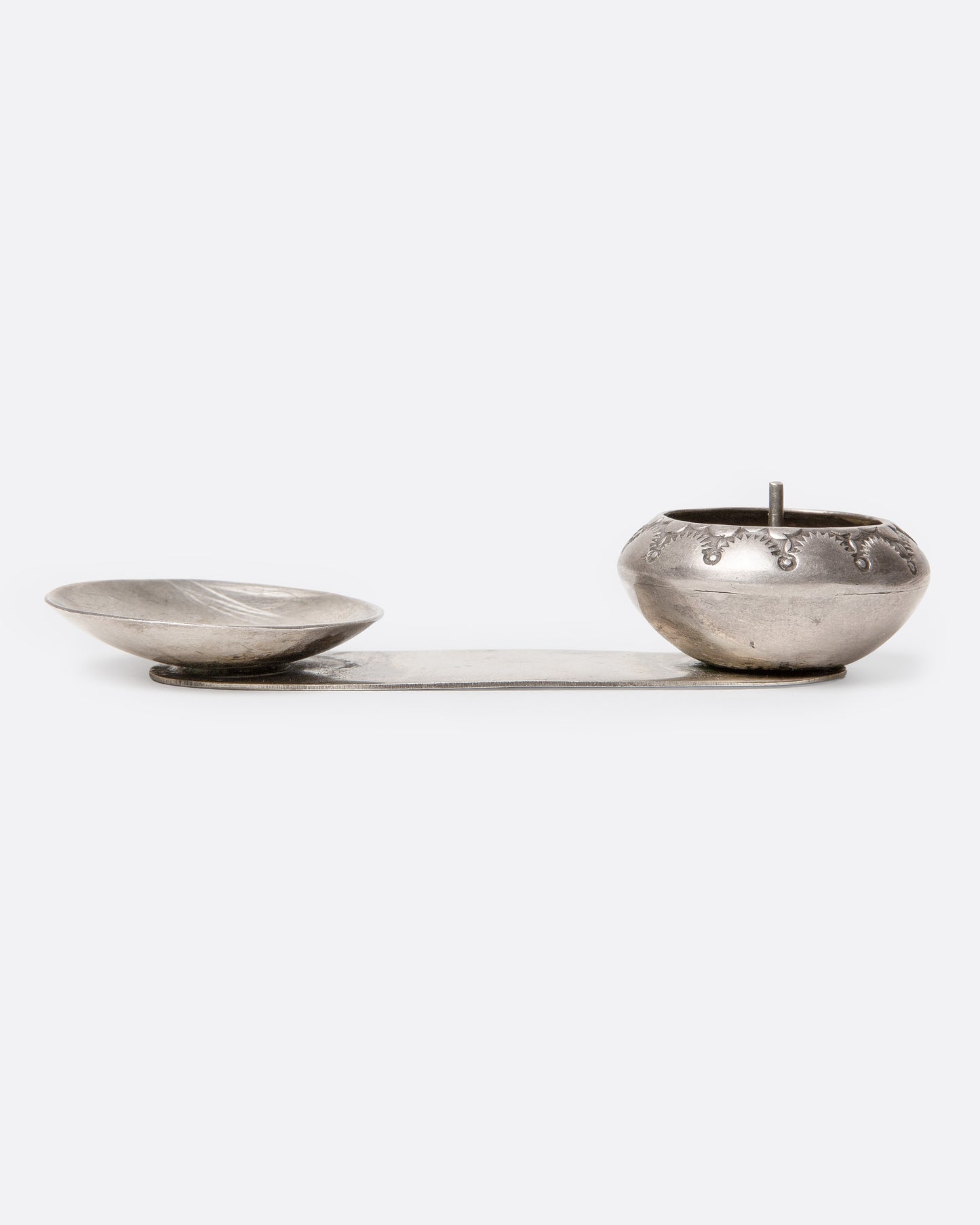 A silver palo santo and incense burner with a bowl and dish. Shown from the front.