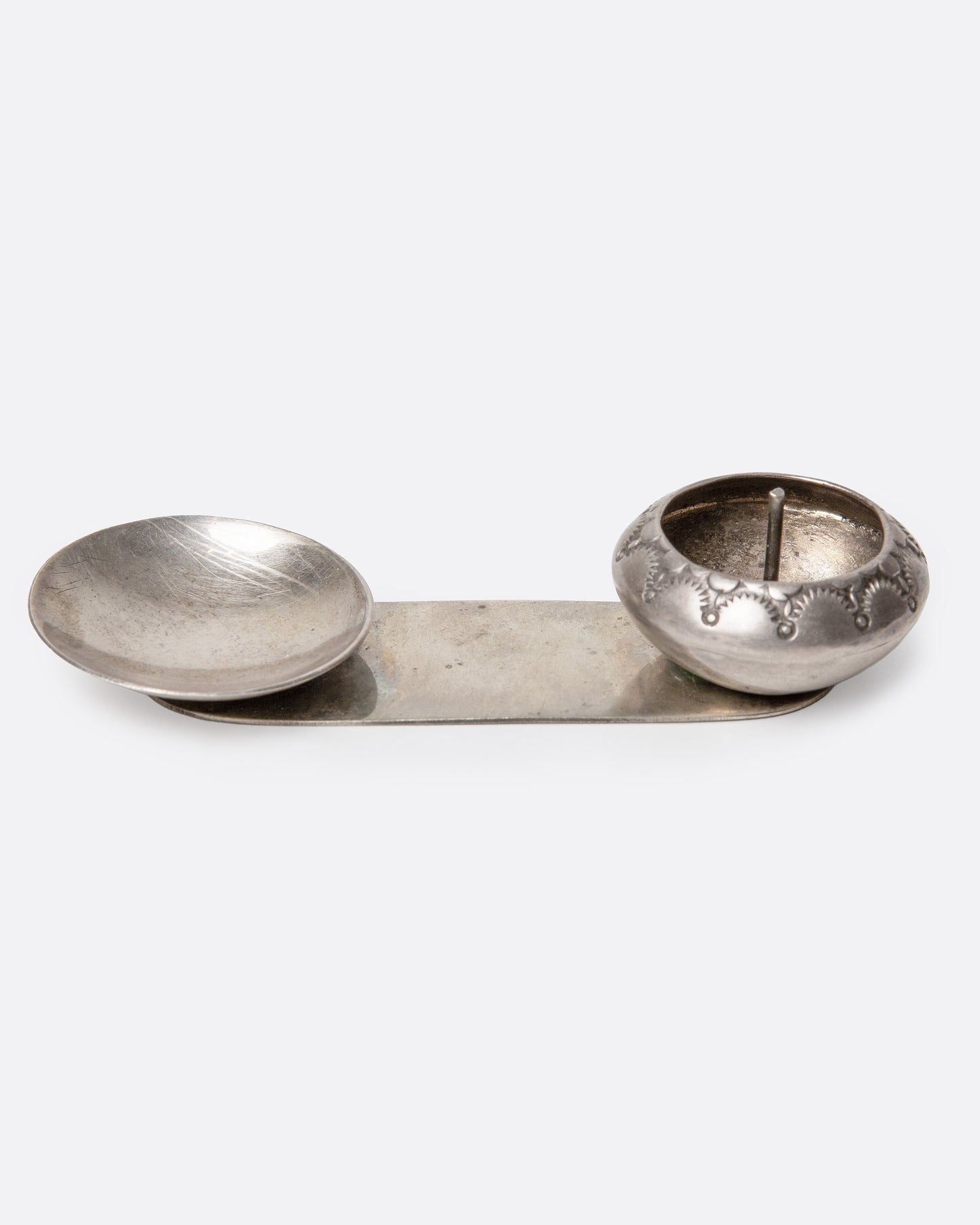 A silver palo santo and incense burner with a bowl and dish. Shown from the front.