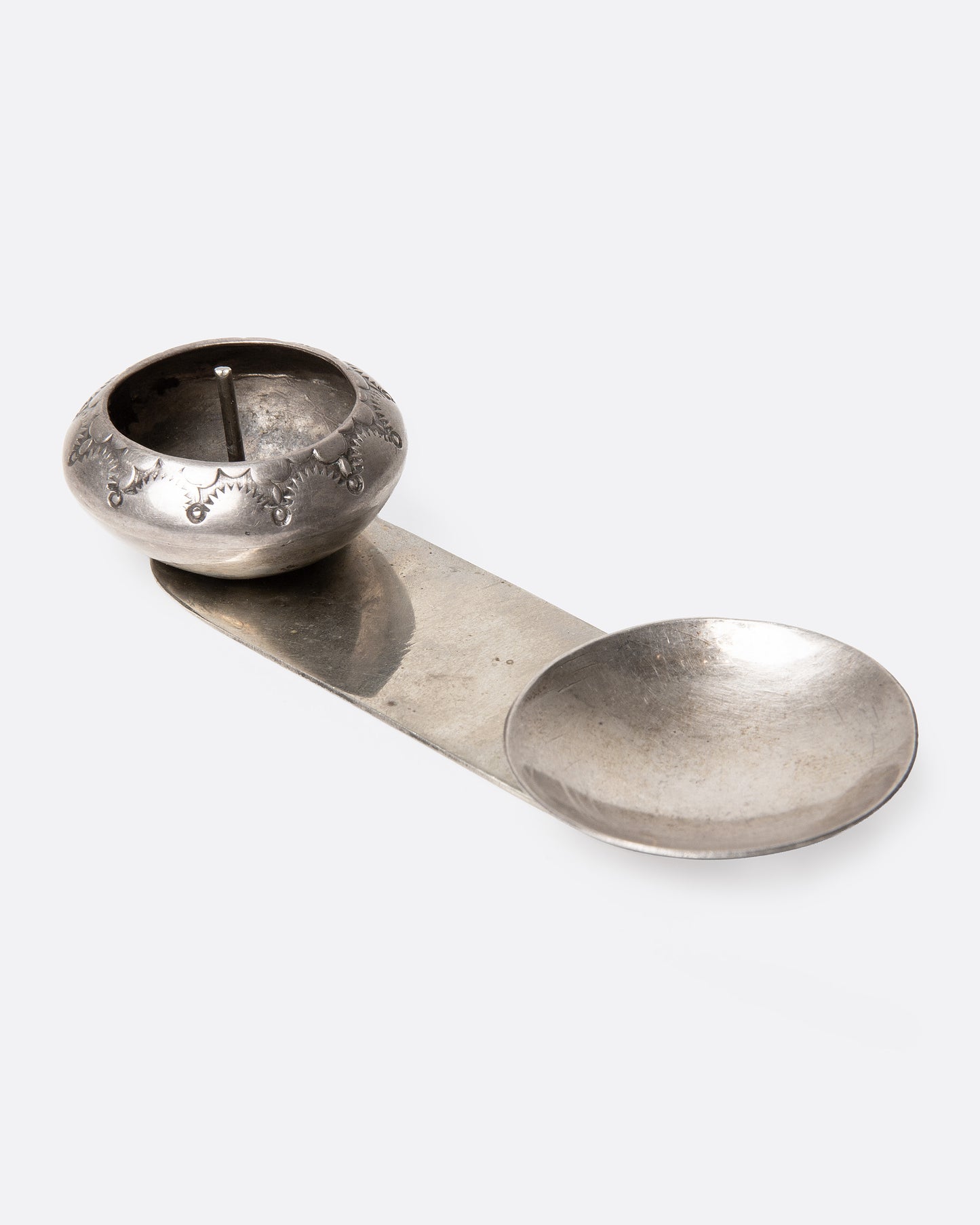 A silver palo santo and incense burner with a bowl and dish. Shown from the side.