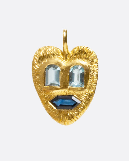 Yellow gold heart face pendant with aquamarine and sapphire, front view of the heart face with emerald-cut aquamarine eyes and a hexagonal sapphire mouth