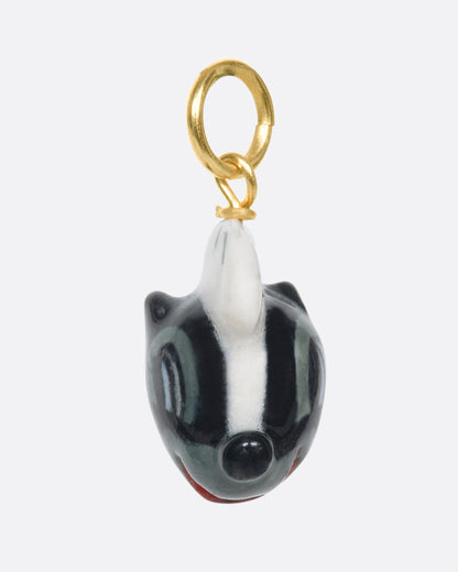 Porcelain skunk head charm, side view of the face