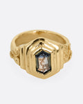 A yellow gold with a stepped center and a portrait cut bicolor tourmaline with a gold tendril that reveals itself through the stone. Shown from the front.