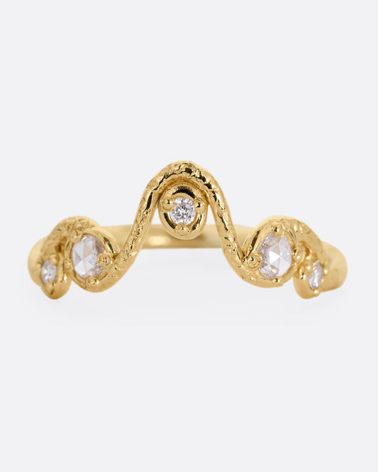 A wavy yellow gold ring with five round diamonds. Shown from the front.