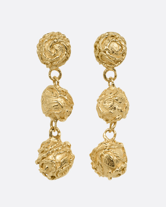 A pair of yellow gold dangle earrings with three linked spheres. Shown from the front.